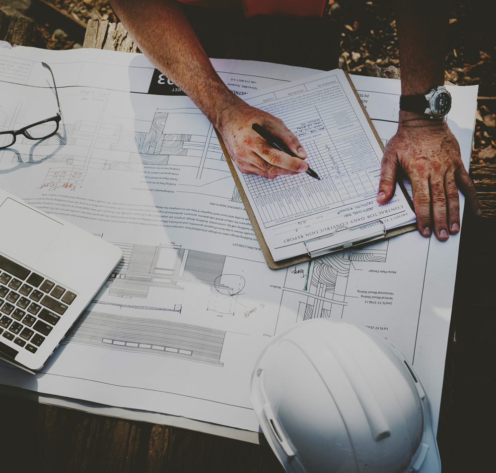 home Inspection contractor inspecting blueprints of house